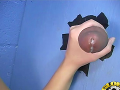 Naughty babe finds a glory hole and sucks a big black cock