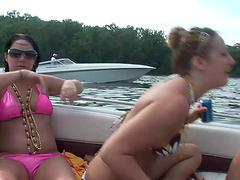 Sexy lesbians in bikini having outdoor fun on a boat