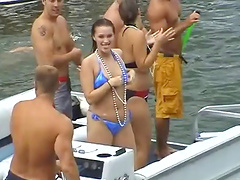 Bikini-clad babe with big tits dancing and having fun on a yacht