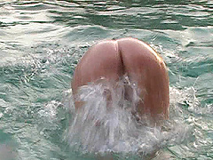 Blonde chick gets naked and goes swimming in the hotel pool