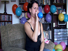 Flirtatious brunette solo model enjoys blowing balloons