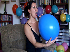 Flirtatious brunette solo model enjoys blowing balloons