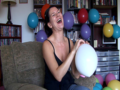 Flirtatious brunette solo model enjoys blowing balloons