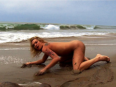 She works up friction on her clit by getting off on the beach