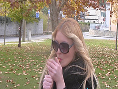 Blonde relaxes outdoors with a smoke and plays with her feet