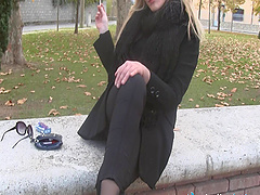 Blonde relaxes outdoors with a smoke and plays with her feet