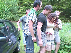 Outdoor group sex on the grass with four dudes and a pregnant whore