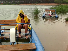 Out on a paddle boat she gets naked and plays with her pussy