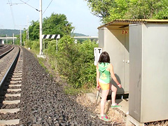 Out by the railroad this teen gets naked and rubs her pussy