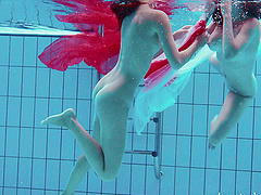 Redhead European lesbian teen getting cozy underwater