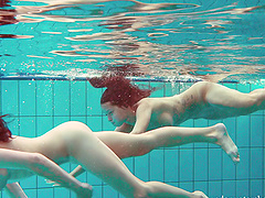 Redhead European lesbian teen getting cozy underwater