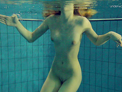 Redhead natural boobs solo model pose seductively underwater