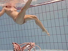 Russian babe Iva Brizgina gets naked and jumps in the swimming pool