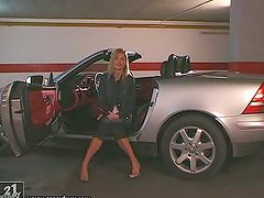 Sexy Sophie Paris poses for the camera naked near a car