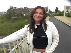 Playful brunette shows her tits and sucks a cock outdoors