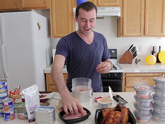 Good looking dude enjoys while cooking dinner in the kitchen