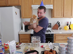 Good looking dude enjoys while cooking dinner in the kitchen