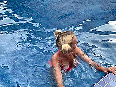 Blonde bombshell gives a sloppy blowjob by the pool