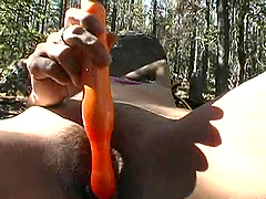 Hot masturbating babe in the woods toy fucking her pussy