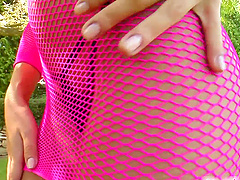 Fishnet brunette Jane drills her pussy with a dildo outdoors