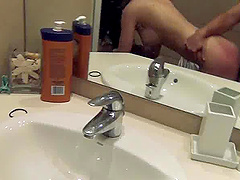 Randy brunette taking cumshot on her face in the bathroom after fucking